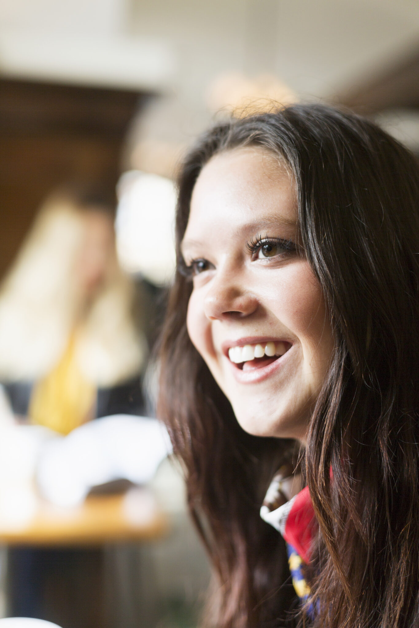 Happy Young Woman Looking Away In Station Cafe
