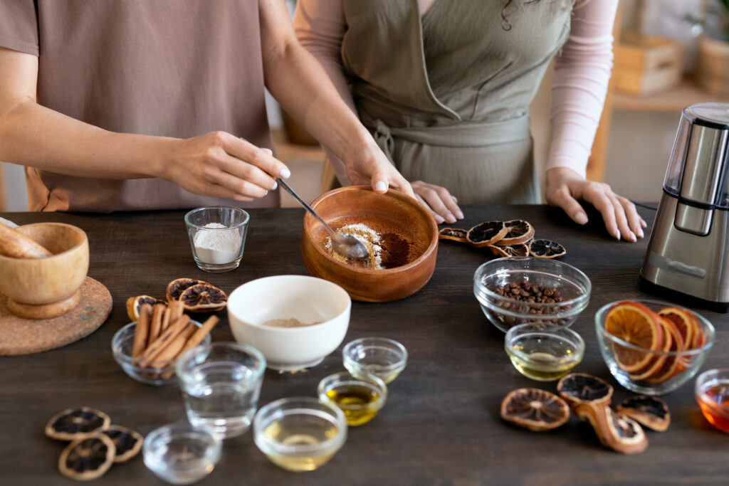 Young Woman Mixing Ground Candied Fruits In Wooden Bowl While Making Soap